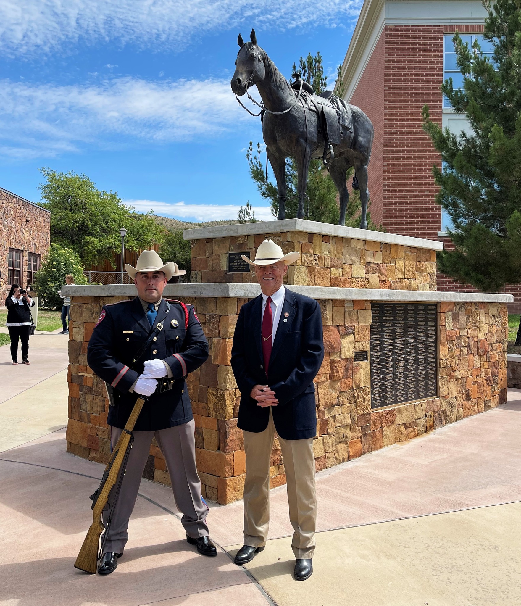 Texas State Trooper Ryan Dalton and Ben H. English stand in front of the Donde Esta? monument on the Sul Ross State University campus in Alpine, TX following the Big Bend Area Law Enforcement Officers Association annual memorial service.