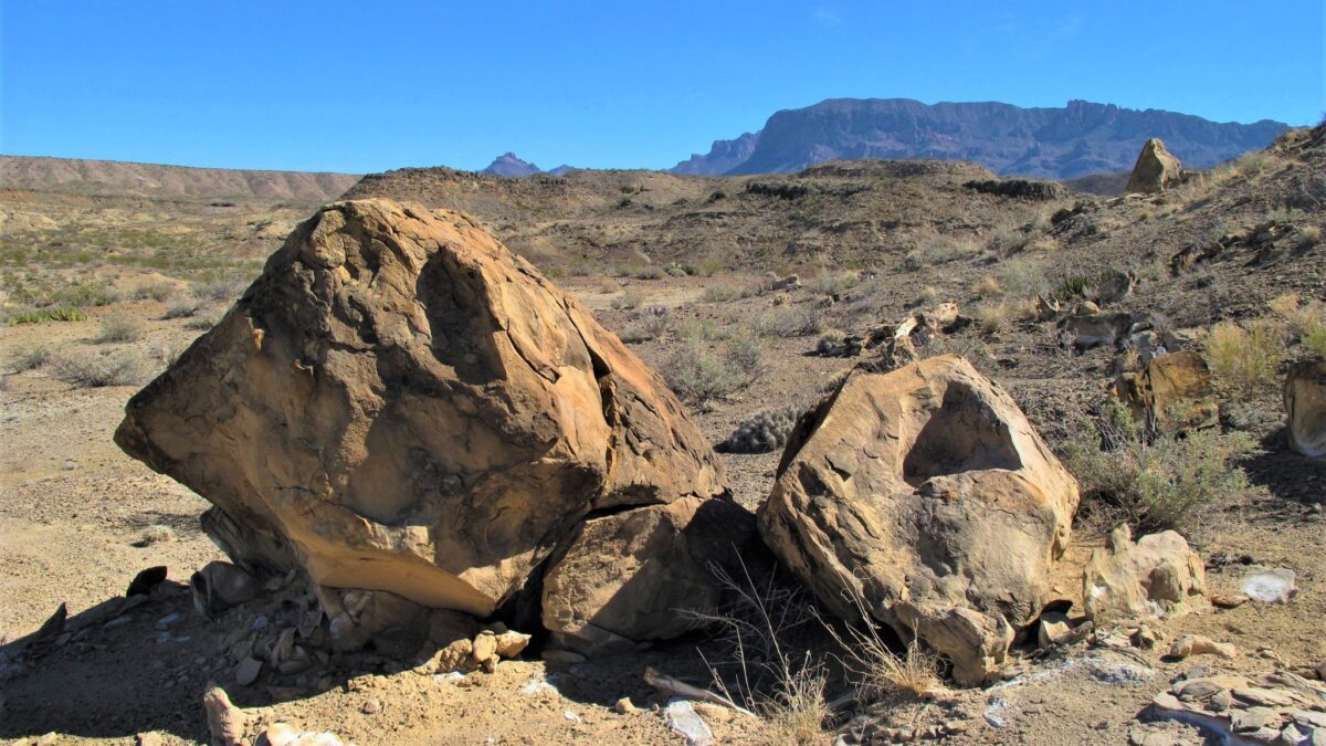 Boulders in the desert with the mountains in the background in Big Bend National Park