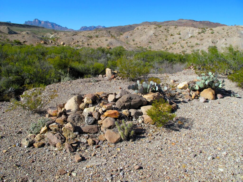 Three remote graves covered in stones in Big Bend National Park.