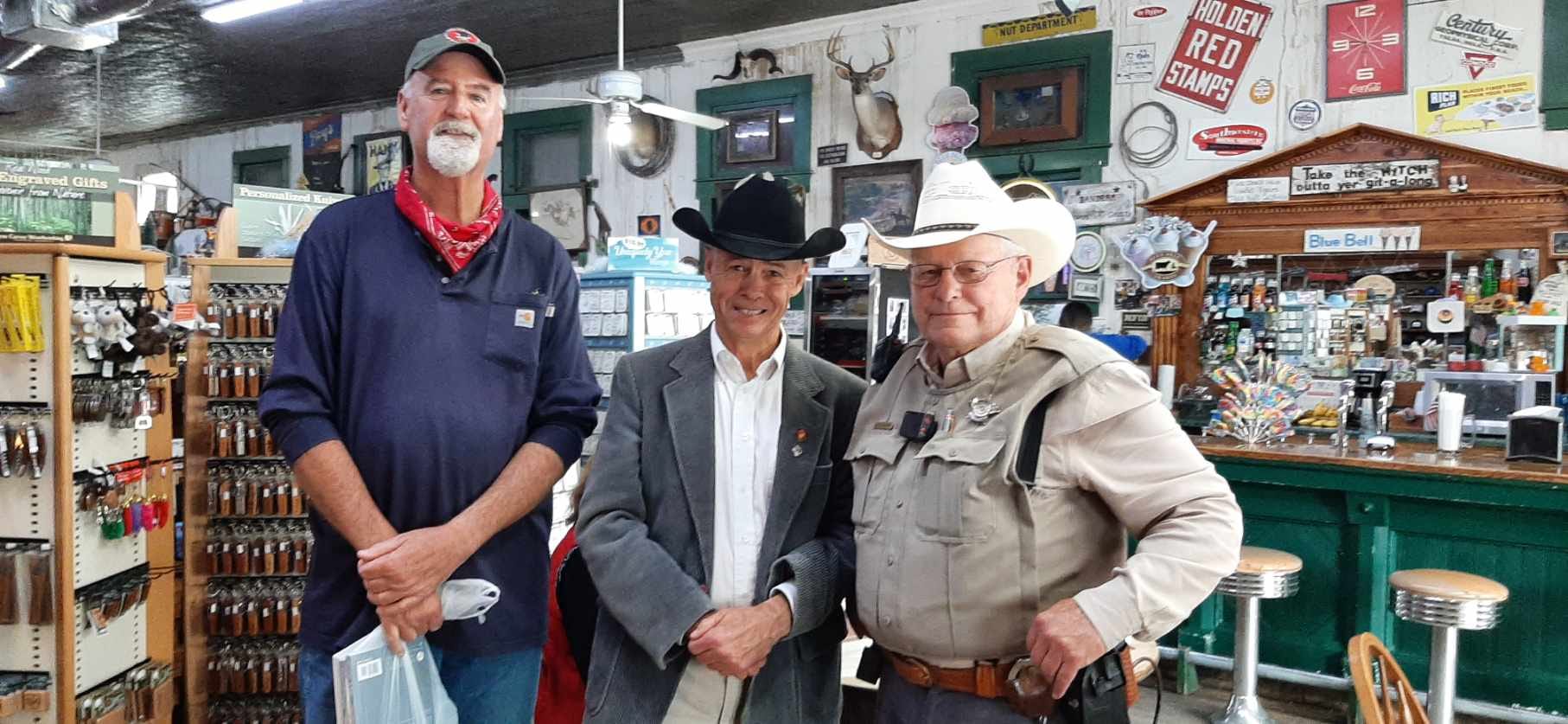 Author Ben H. English stands with two supporters at the Bandera General Store.
